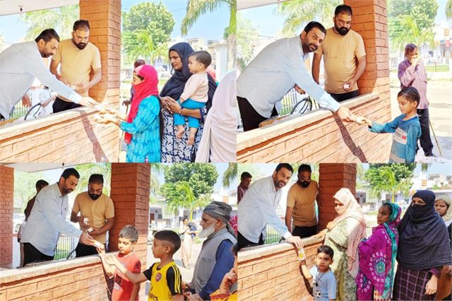 Distributing Juices among the Children of Jhuggi-Jhopdi
