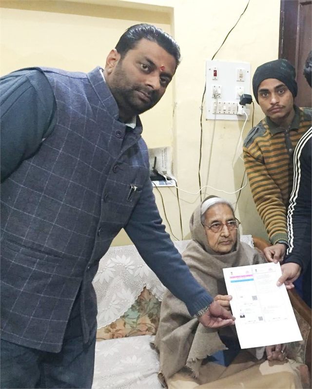 Handing Over Aadhaar Card to a physically challenged Man